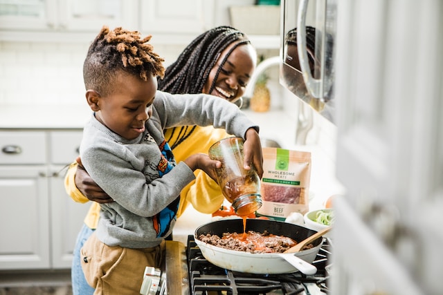 Mother and son cooking in the kitchen